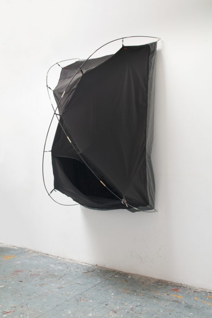 Kasia Ozga, Soft sculpture sewn from blackout fabric, black string, tent poles, tarp. (2019)